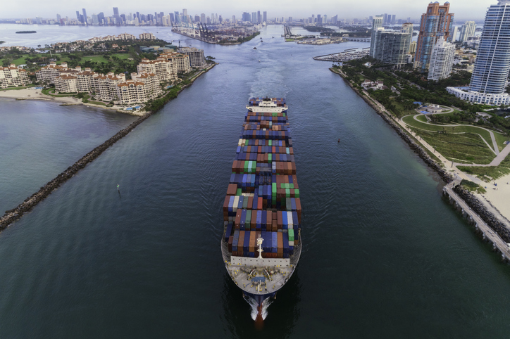 Ariel view of a large cargo ship moving through the Port of Miami
