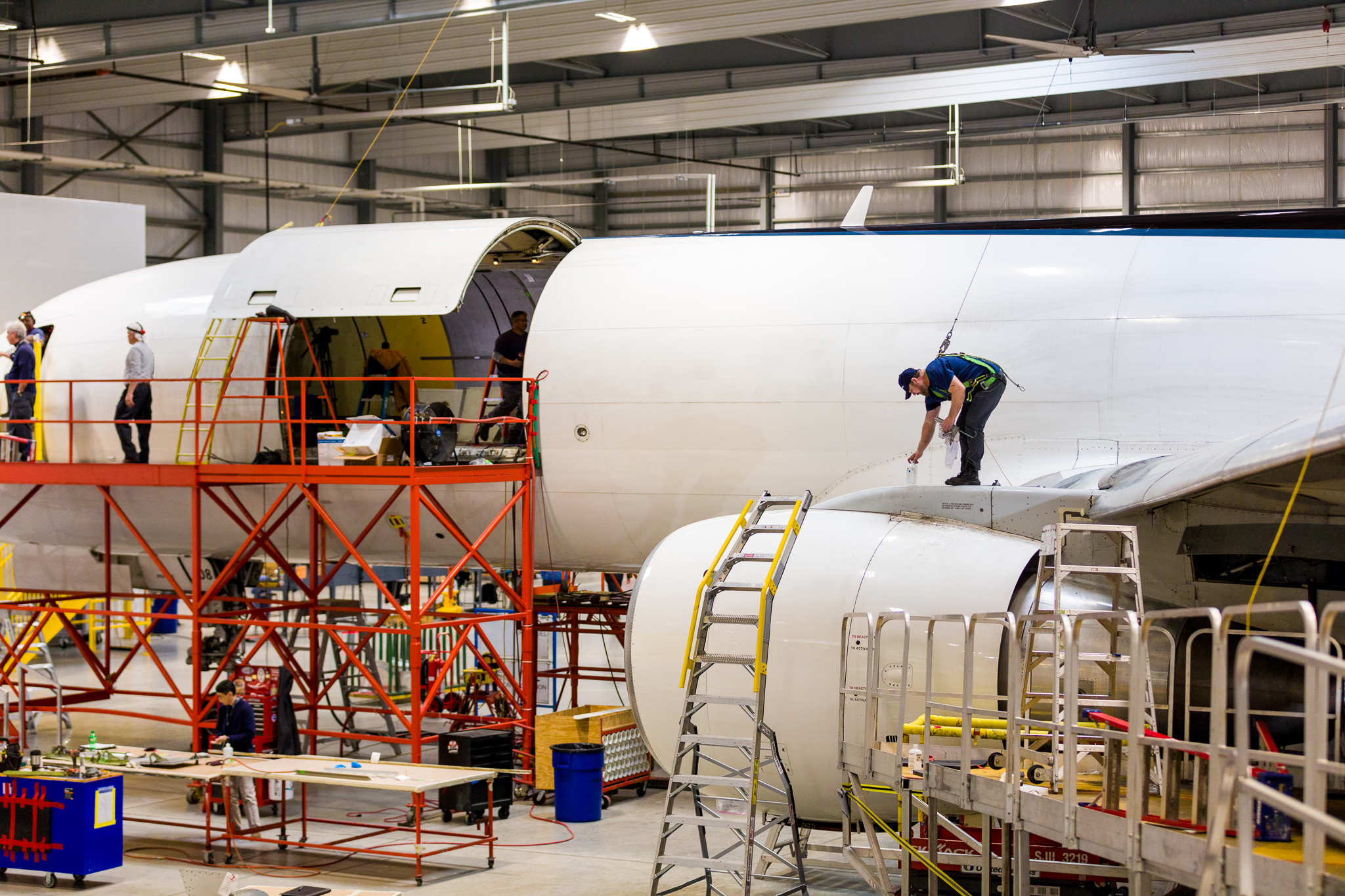 Aviation employees in Florida’s workforce construct an fairplane’s outer shell